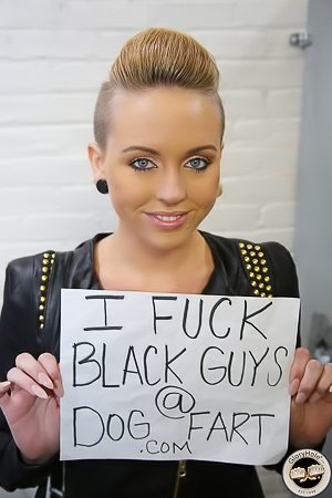 Blond-haired beauty with shaved sides enjoying black cocks via a glory hole