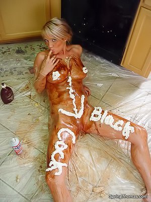 Blonde teen cooking in the kitchen, covering her naked body with cream